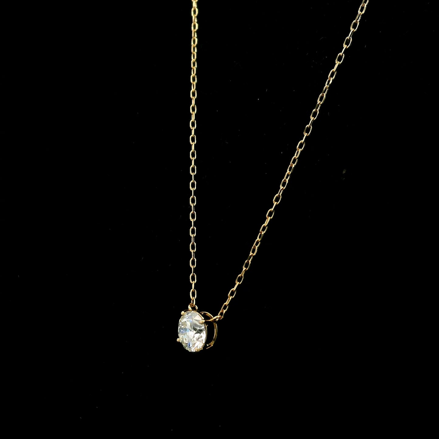18K yellow gold solitaire necklace featuring a 1.01 carat GIA certified round brilliant natural diamond in a classic four-prong setting.