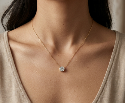 18K yellow gold solitaire necklace featuring a 1.01 carat GIA certified round brilliant natural diamond in a classic four-prong setting.