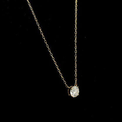 18K yellow gold solitaire necklace featuring a 1.01 carat GIA certified round brilliant natural diamond in a classic four-prong setting.