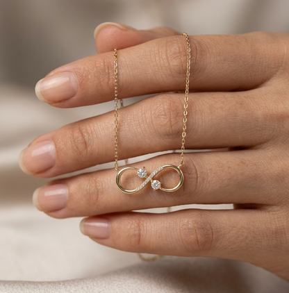 18K yellow gold infinity diamond necklace with round natural diamonds and pavé-set infinity pendant, handcrafted fine jewellery by Emirates Diamonds.