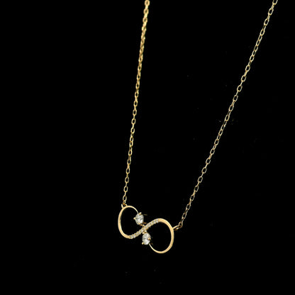 18K yellow gold infinity diamond necklace with round natural diamonds and pavé-set infinity pendant, handcrafted fine jewellery by Emirates Diamonds.