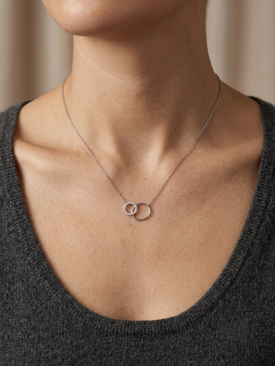 Interlocking circle diamond necklace in 18K white gold with one pavé diamond circle and one polished circle.