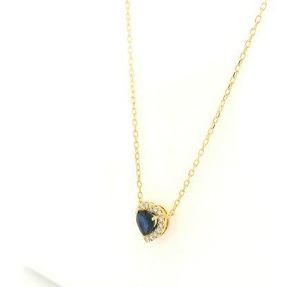 Heart-shaped blue sapphire and diamond halo pendant necklace in 18K yellow gold.