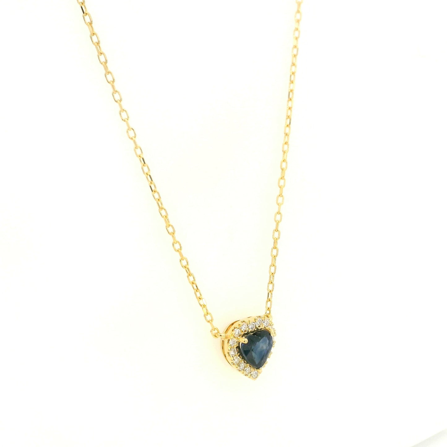 Heart-shaped blue sapphire and diamond halo pendant necklace in 18K yellow gold.
