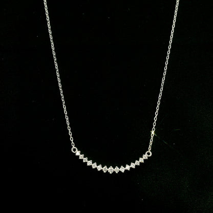 Diamond curved bar necklace in 18K white gold featuring a gently curved row of round diamonds with a total weight of 0.18 carat, connected to a fine white gold chain.