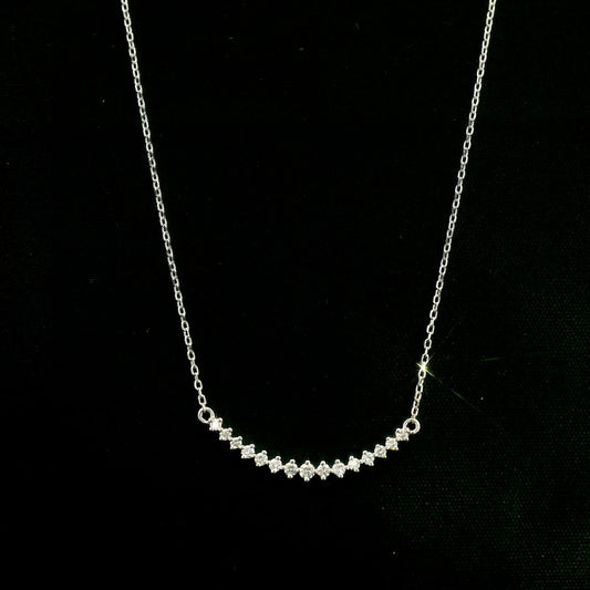 Diamond curved bar necklace in 18K white gold featuring a gently curved row of round diamonds with a total weight of 0.18 carat, connected to a fine white gold chain.