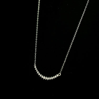 Diamond curved bar necklace in 18K white gold featuring a gently curved row of round diamonds with a total weight of 0.18 carat, connected to a fine white gold chain.