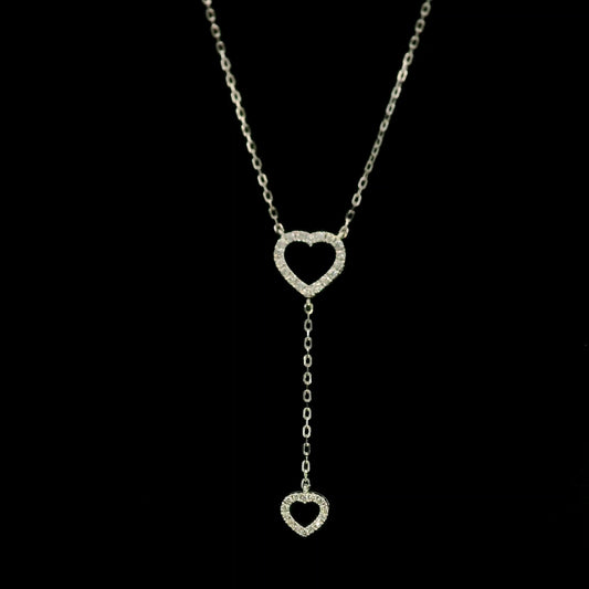 Diamond double heart Y necklace in 18K white gold featuring a larger open diamond heart at the neckline and a smaller diamond heart suspended from a delicate vertical drop chain, with 0.23 carat total diamond weight.
