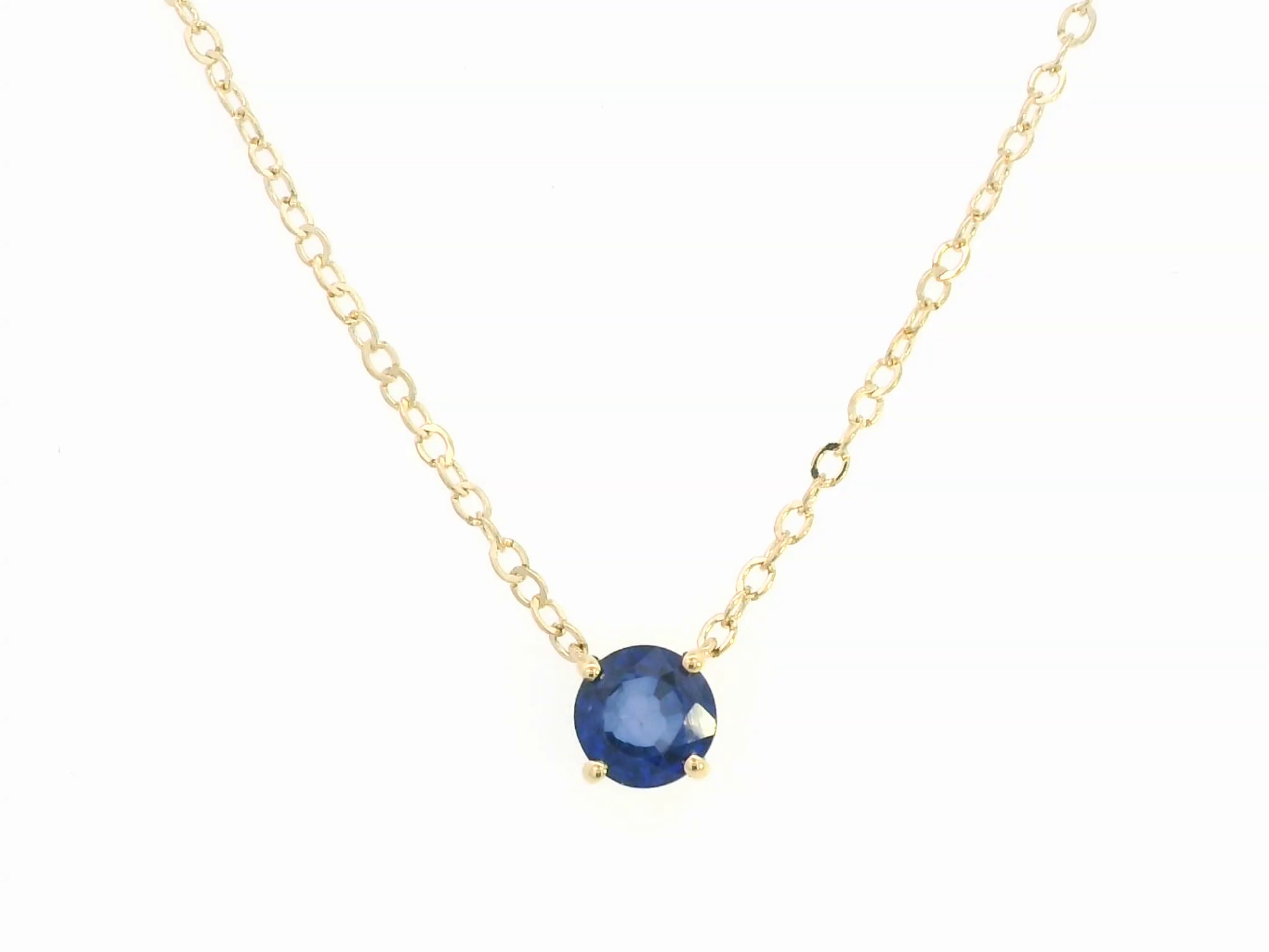 18K gold necklace featuring a round 0.89 carat blue sapphire pendant on a fine gold cable chain. Minimalist design with timeless elegance.

