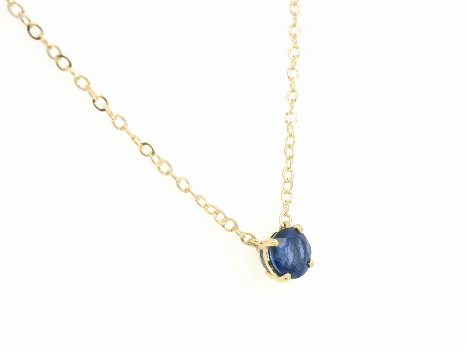 18K gold necklace featuring a round 0.89 carat blue sapphire pendant on a fine gold cable chain. Minimalist design with timeless elegance.

