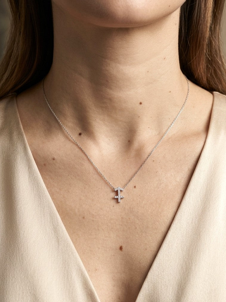 Sagittarius zodiac necklace in 18K white gold featuring a diamond-set Sagittarius arrow symbol pendant suspended from a delicate white gold chain against a dark background.