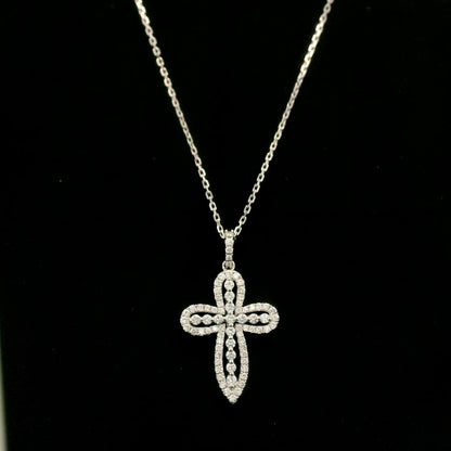 Openwork diamond cross pendant in 18K white gold with round diamond borders, central diamond accents and a diamond-set bail, displayed on a chain.