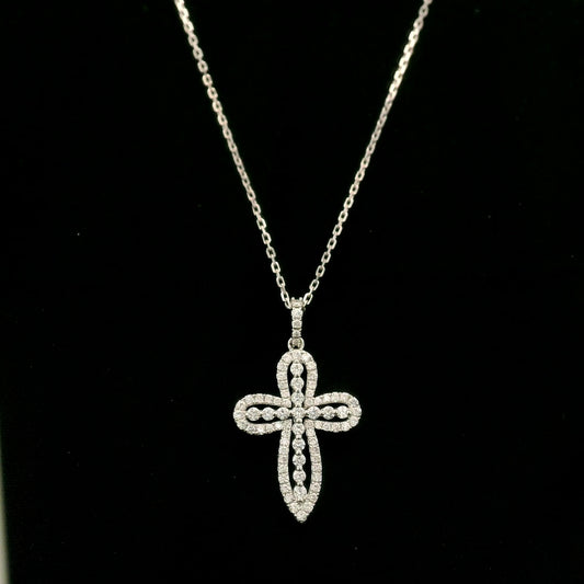 Openwork diamond cross pendant in 18K white gold with round diamond borders, central diamond accents and a diamond-set bail, displayed on a chain.