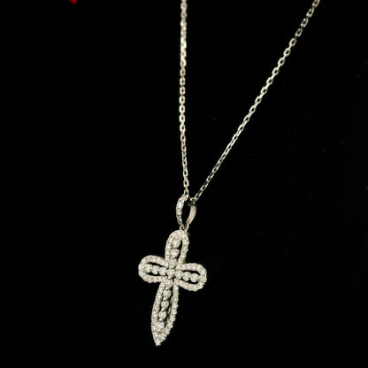Openwork diamond cross pendant in 18K white gold with round diamond borders, central diamond accents and a diamond-set bail, displayed on a chain.