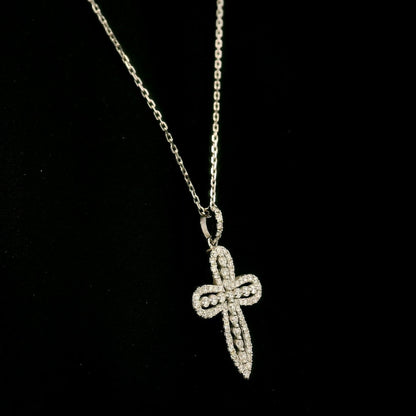 Openwork diamond cross pendant in 18K white gold with round diamond borders, central diamond accents and a diamond-set bail, displayed on a chain.