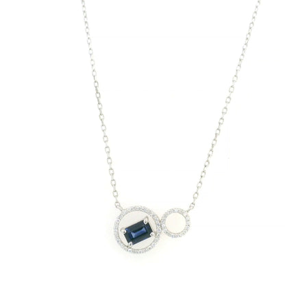 Blue emerald-cut sapphire and diamond necklace in 18K white gold, featuring an asymmetrical double-circle design with round diamond accents.