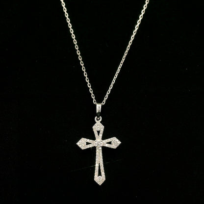 Diamond cross pendant in 18K white gold with round diamonds, an openwork design and distinctive pointed ends.