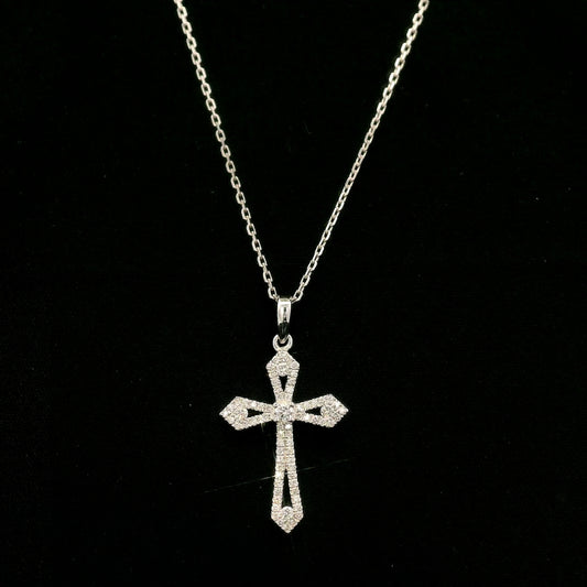 Diamond cross pendant in 18K white gold with round diamonds, an openwork design and distinctive pointed ends.