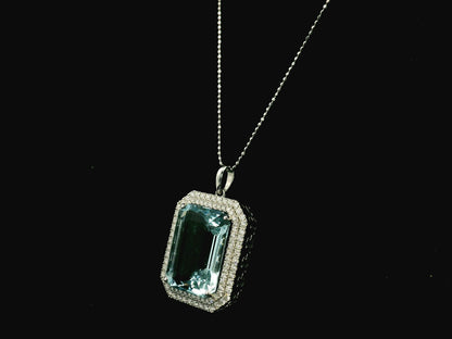 Emerald-cut aquamarine and diamond halo pendant in 18K white gold with large natural aquamarine center stone