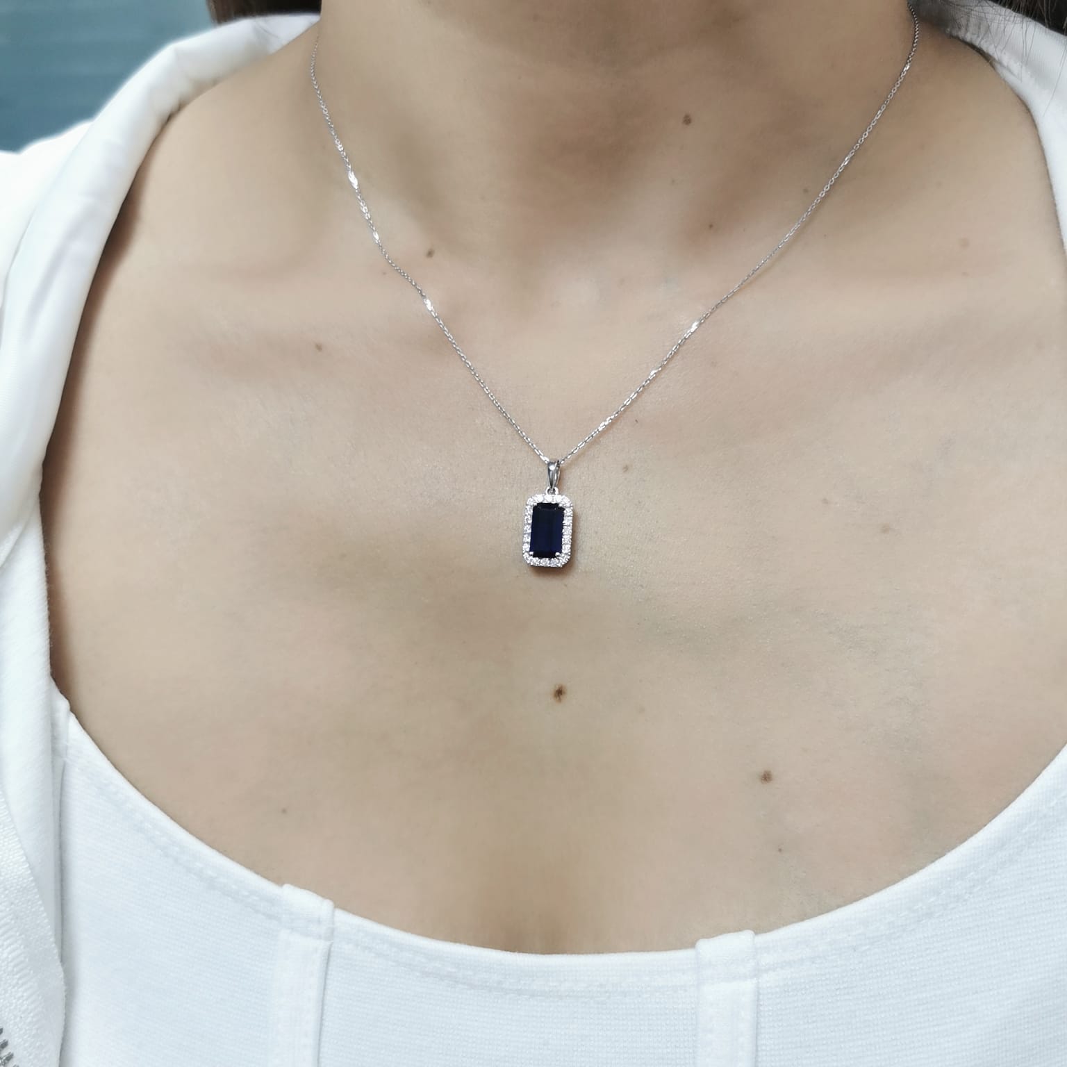 18K gold sapphire pendant featuring a 1.92 CT emerald-cut sapphire with a 0.31 CT diamond halo, available without a chain for a customizable look