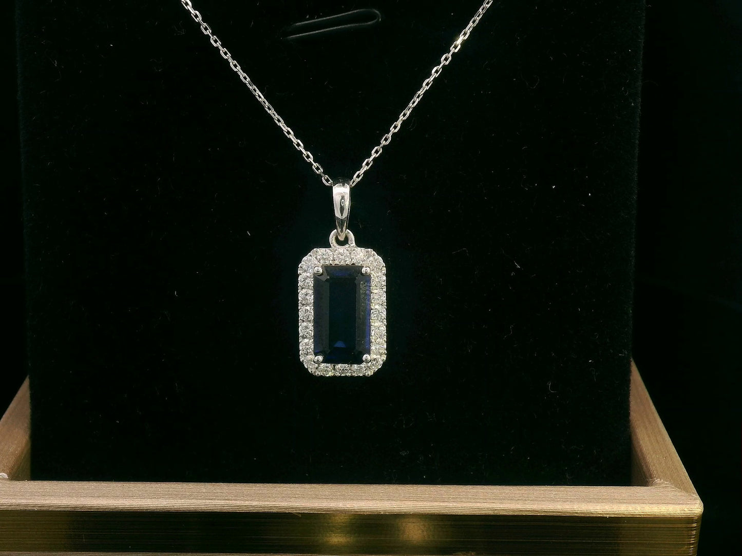 18K gold sapphire pendant featuring a 1.92 CT emerald-cut sapphire with a 0.31 CT diamond halo, available without a chain for a customizable look