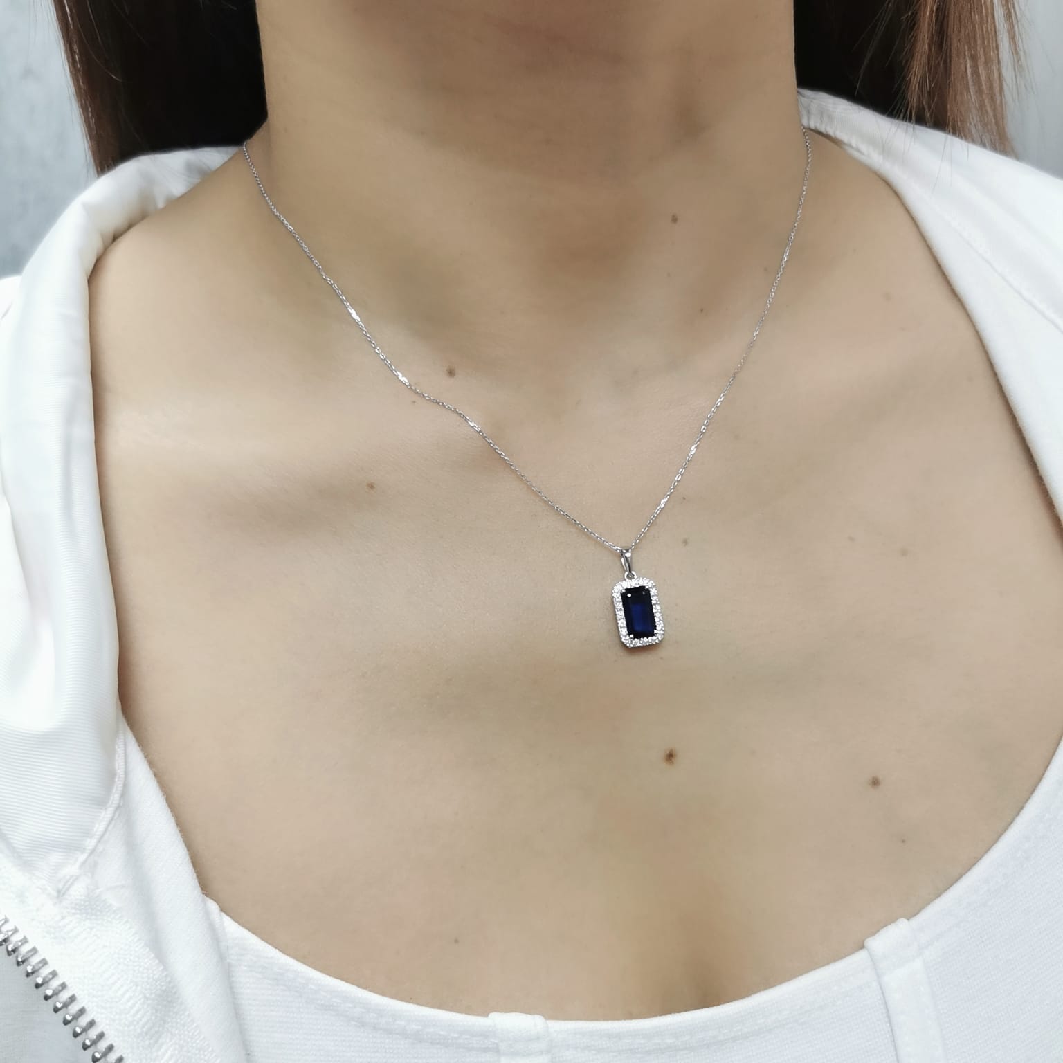 18K gold sapphire pendant featuring a 1.92 CT emerald-cut sapphire with a 0.31 CT diamond halo, available without a chain for a customizable look