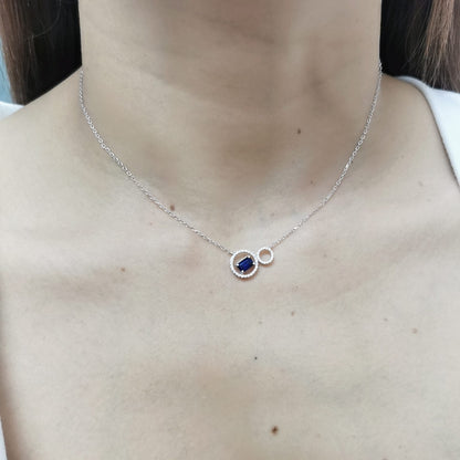 18K white gold necklace featuring a 0.65 CT emerald-cut sapphire with a 0.15 CT diamond halo, designed with a unique double-circle pendant for a sophisticated, modern look.