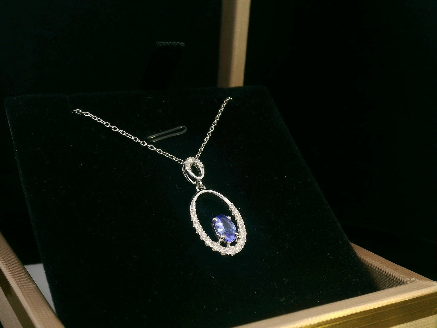 18K white gold tanzanite and diamond oval pendant featuring a 0.47ct violet-blue tanzanite and 0.21ct diamonds, designed for layering