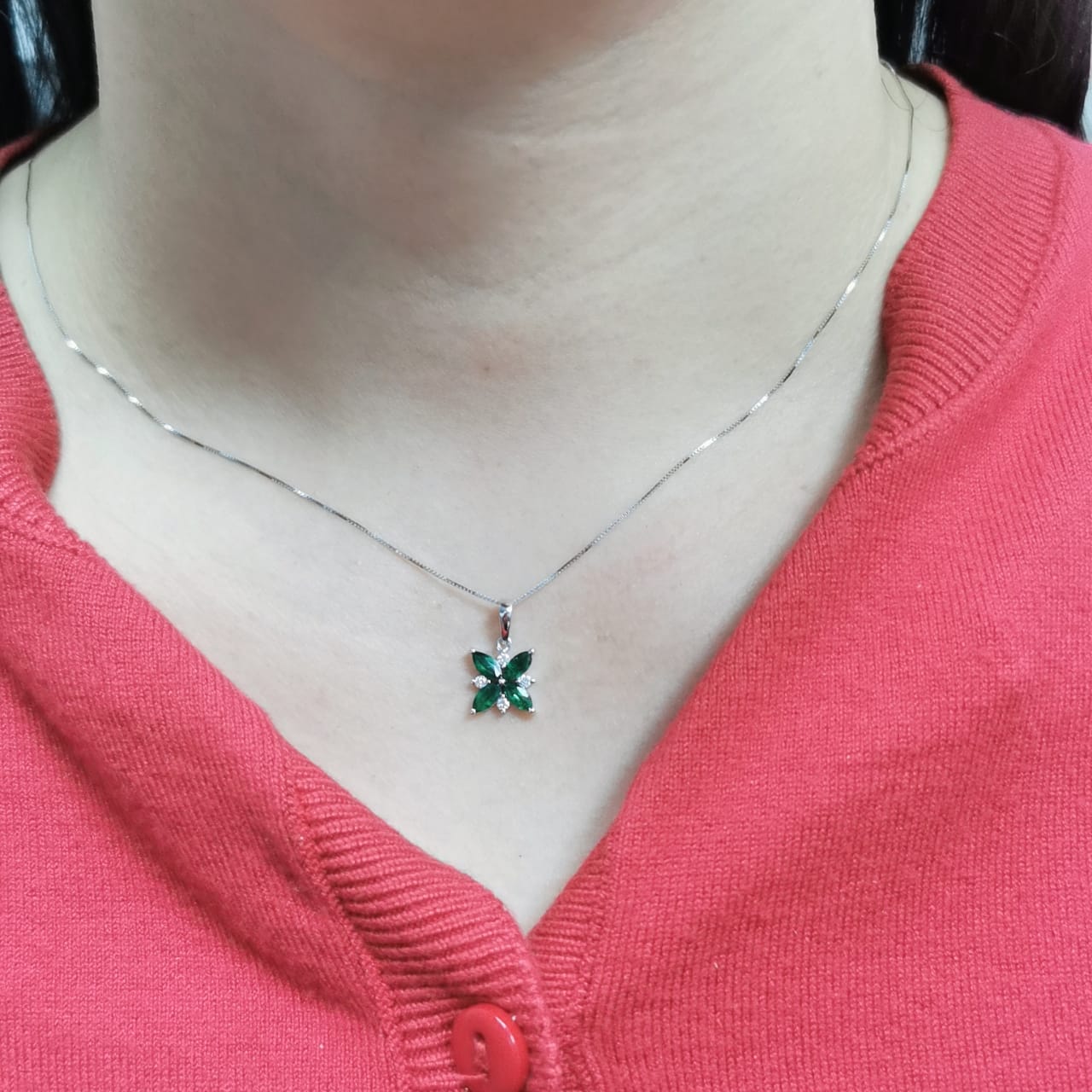 18K gold floral pendant featuring 0.57 CT natural emeralds and 0.07 CT diamonds, designed in a delicate flower shape. Chain not included.