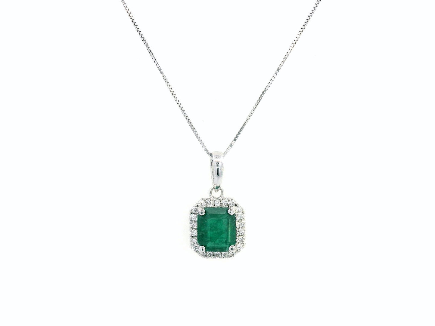 18K gold emerald-cut emerald and diamond halo pendant featuring a 1.12-carat vibrant green emerald with 0.12-carat round diamonds, a timeless fine jewelry piece.