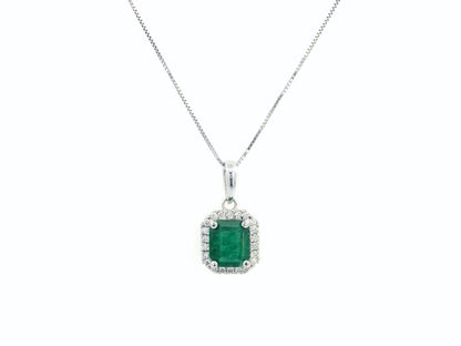 18K gold emerald-cut emerald and diamond halo pendant featuring a 1.12-carat vibrant green emerald with 0.12-carat round diamonds, a timeless fine jewelry piece.