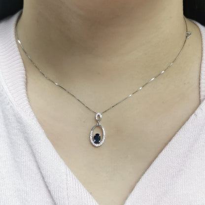 18K white gold oval pendant featuring a 0.70 carat sapphire with 0.15 carats of diamonds