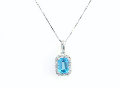 Emerald-cut blue topaz pendant with diamond halo in 18K gold, featuring a 1.40-carat gemstone and 0.13-carat diamonds.