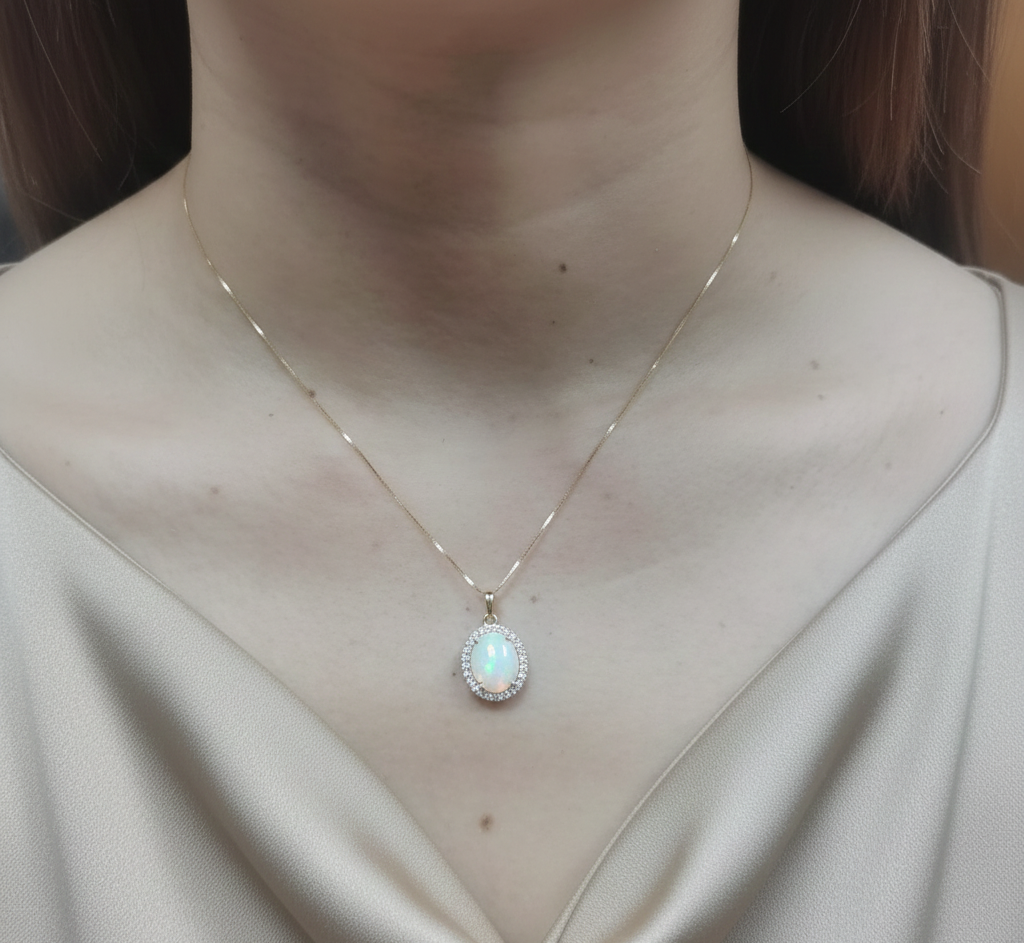 18K yellow gold opal and diamond halo pendant with 1.68 carat opal by Emirates Diamonds