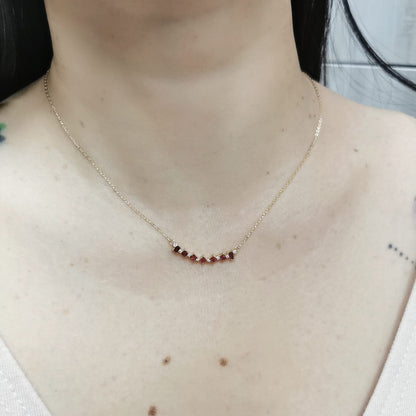 Elegant 18K gold necklace with square-cut rubies (0.67ct) and round diamonds (0.08ct), set on a fine gold chain – perfect July birthstone jewelry.