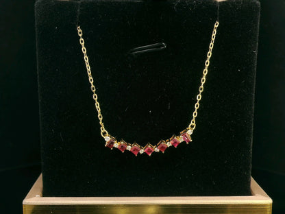 Elegant 18K gold necklace with square-cut rubies (0.67ct) and round diamonds (0.08ct), set on a fine gold chain – perfect July birthstone jewelry.