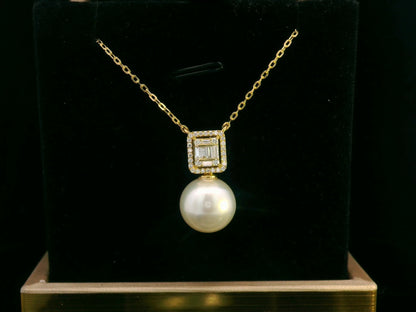 18K gold pendant featuring a South Sea pearl with a 0.26ct diamond halo of baguette and round diamonds.