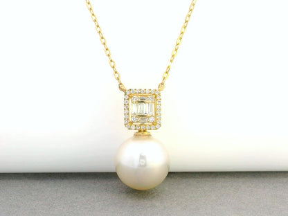 18K gold pendant featuring a South Sea pearl with a 0.26ct diamond halo of baguette and round diamonds.