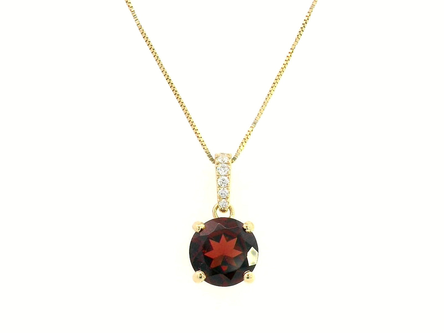 18K gold pendant with a 2.03ct deep red garnet in a four-prong setting, accented by 0.06ct diamonds on the bail. Chain not included.