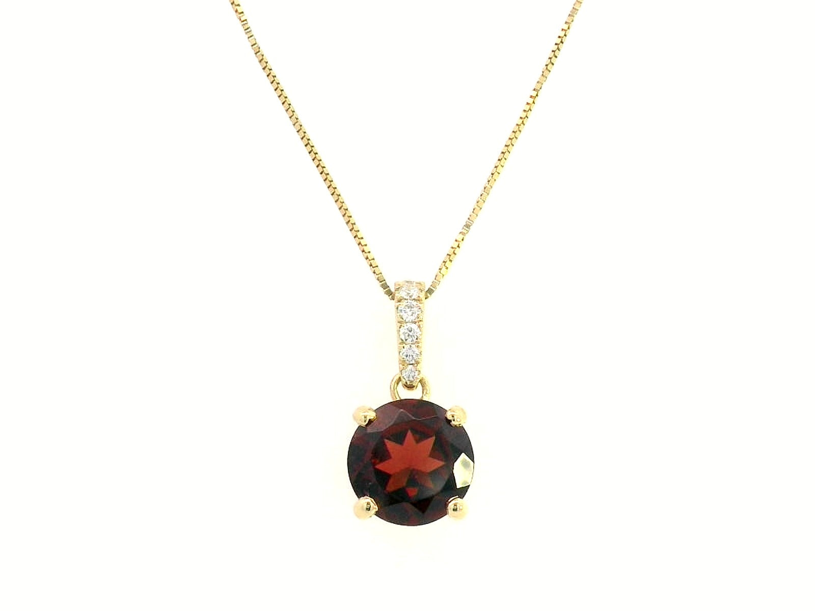 18K gold pendant with a 2.03ct deep red garnet in a four-prong setting, accented by 0.06ct diamonds on the bail. Chain not included.