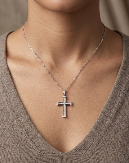 Diamond cross pendant in 18K white gold featuring an openwork design with round diamonds and diamond-accented ends.