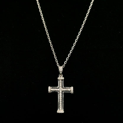 Diamond cross pendant in 18K white gold featuring an openwork design with round diamonds and diamond-accented ends.