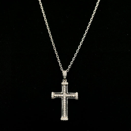 Diamond cross pendant in 18K white gold featuring an openwork design with round diamonds and diamond-accented ends.