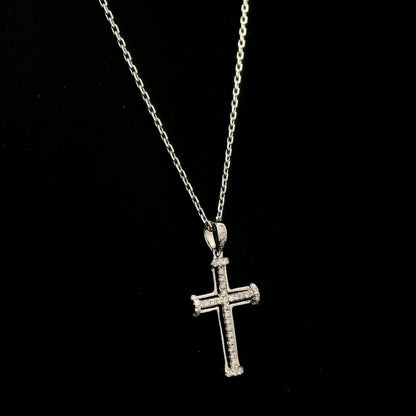 Diamond cross pendant in 18K white gold featuring an openwork design with round diamonds and diamond-accented ends.