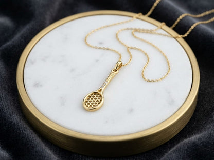 18K yellow gold tennis racket pendant necklace with diamond accents by Emirates Diamonds