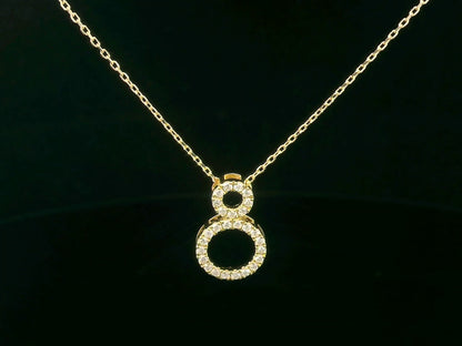 18K gold pendant necklace with double open circle design set with 0.18 carat pavé diamonds