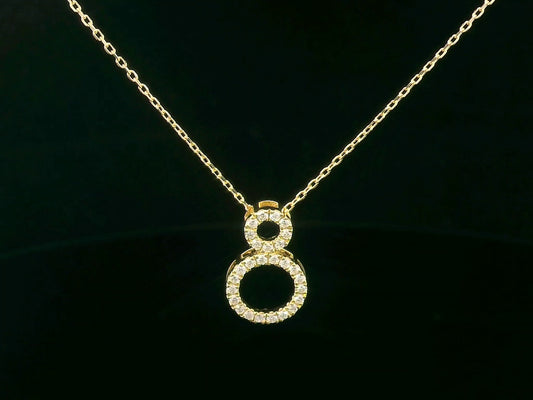 18K gold pendant necklace with double open circle design set with 0.18 carat pavé diamonds