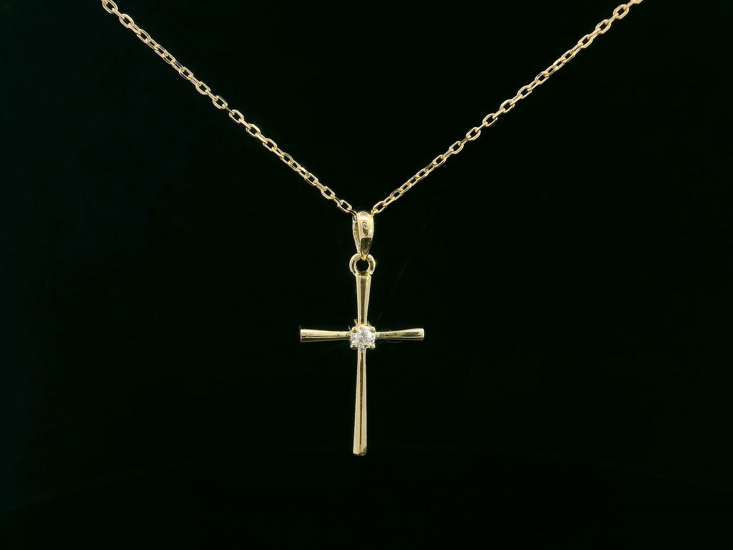 18K yellow gold cross pendant with 0.05 carat center diamond, minimalist design, chain not included