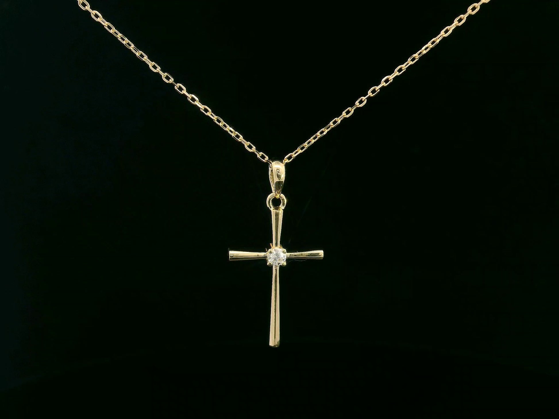 18K yellow gold cross pendant with 0.05 carat center diamond, minimalist design, chain not included