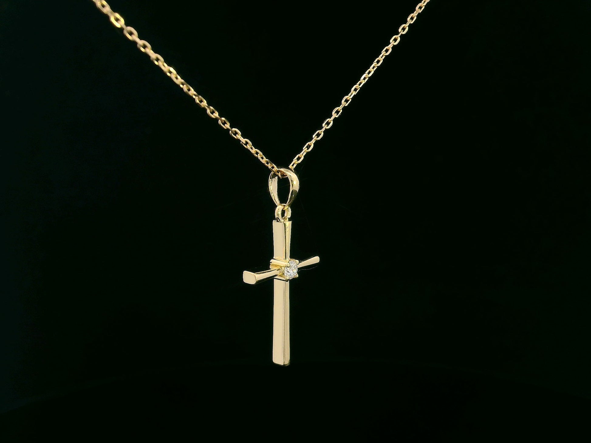 18K yellow gold cross pendant with 0.05 carat center diamond, minimalist design, chain not included